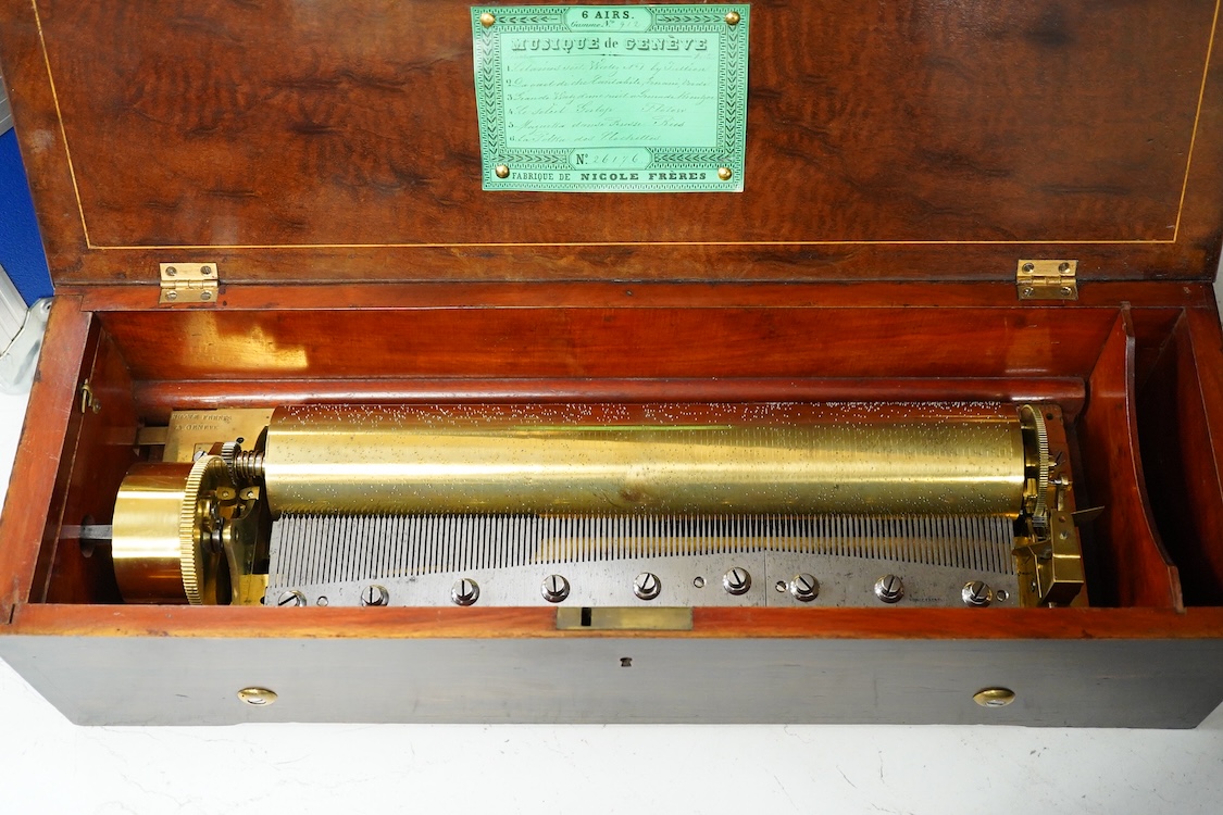 A 19th century Swiss cylinder music box by Nicole Freres, Geneve, key wound movement (with key present) playing six airs, in an inlaid rosewood case, cylinder 33cm long, the case; 52cm long, 13cm high, 17.5cm deep